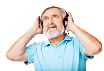 Old man enjoying music