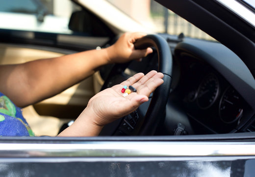 Women taking pills inside his car