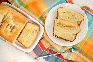 Mascarpone cake slice, long fork on white bright background top