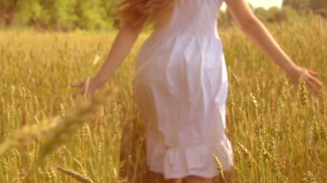 Beauty girl with healthy long hair having fun on wheat field