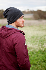 Handsome guy with beard in the field thinking