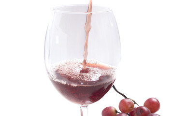 is poured into a glass of red wine