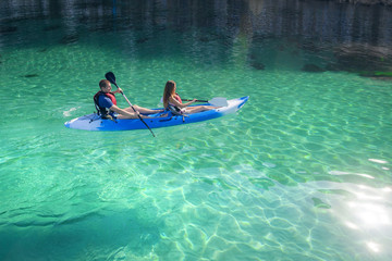 Kayaking. Young happy couple traveling kayak Activities on water