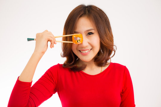 Close-up. young lady eating sushi roll