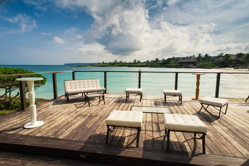 Fototapeta na wymiar Outdoor restaurant at the seashore. Table setting in tropical