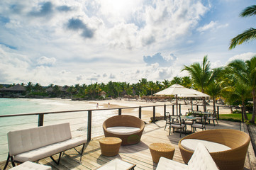 Outdoor restaurant at the seashore. Table setting in tropical