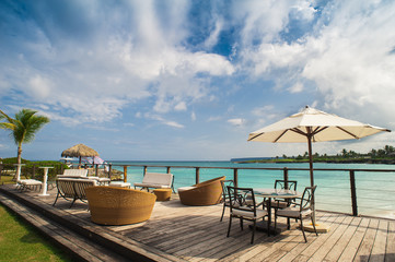 Outdoor restaurant at the seashore. Table setting in tropical