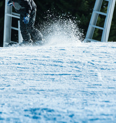 Obraz na płótnie Canvas Snowboarding fast with snow trail