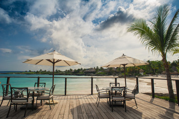 Outdoor restaurant at the seashore. Table setting in tropical
