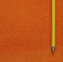 yellow pencil on orange texture background