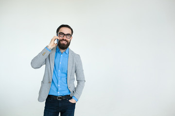 Hipster in glasses talking phone isolated on white background