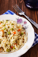 A plate of rice with vegetables