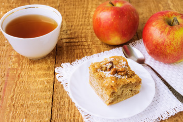 Homemade apple pie and tea on wooden table