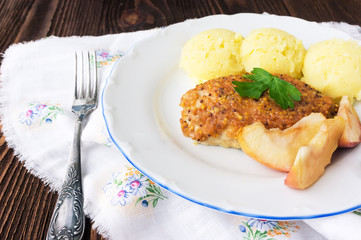 Baked chicken cutlet with apples, selective focus