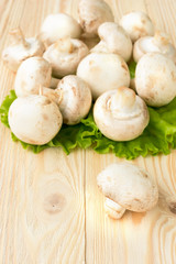 Fresh champignons on a pine wooden table