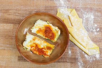 italian lasagna with tomato inside ceramic bowl