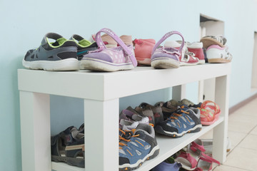 White shoe shelf with children shoes