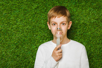 Boy breathing through inhalator mask