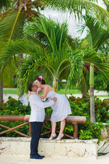 Fototapeta na wymiar Young loving couple on tropical sea background - wedding at the