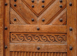 Brown wooden door with metal rivets