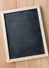 Closeup of vertical empty blackboard with wooden frame