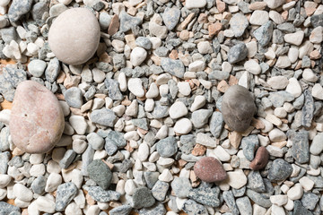 Macro texture of colorful pebbles lying on seashore