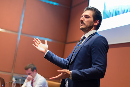 Speaker giving talk at Business Conference.