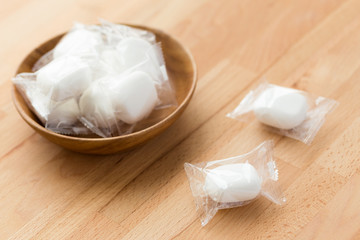 Marshmallow in wooden bowl on wooden table