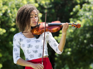 Woman playing a violin outdoors