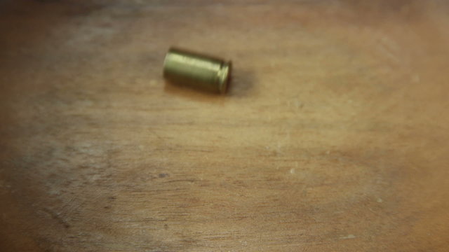 Bullet casing rocking back and fourth coming to rest at center