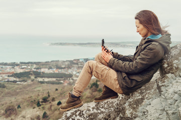 Hiker young woman searching direction with a compass