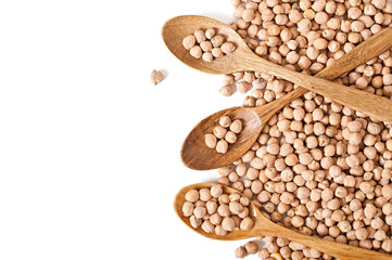 Uncooked chickpeas in wooden spoon on white background
