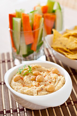 Healthy homemade hummus with vegetables, olive oil and pita chip