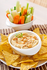 Healthy homemade hummus with vegetables, olive oil and pita chip