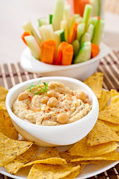 Healthy homemade hummus with vegetables, olive oil and pita chip