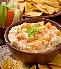 Healthy homemade hummus with vegetables, olive oil and pita chip