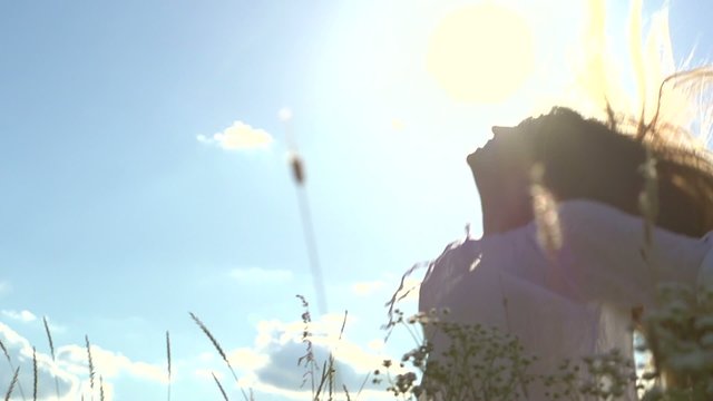 Beautiful young woman over cloudy sky having fun