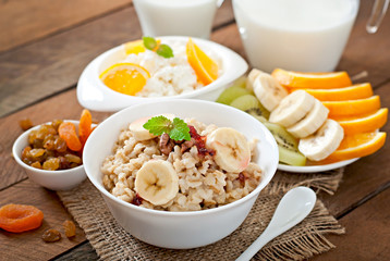 Healthy breakfast - oatmeal, cottage cheese, milk and fruit