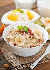 Healthy breakfast - oatmeal, cottage cheese, milk and fruit