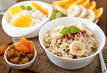 Healthy breakfast - oatmeal, cottage cheese, milk and fruit