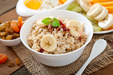 Healthy breakfast - oatmeal, cottage cheese, milk and fruit