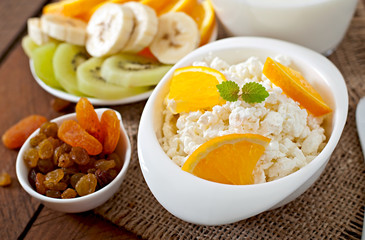 Cottage cheese with orange for breakfast close up