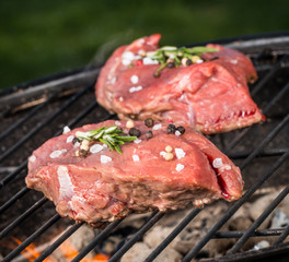 Raw beef steaks on grill