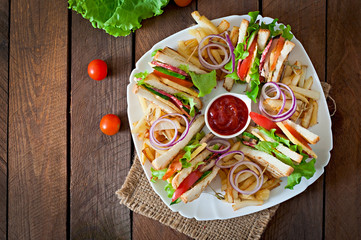 Club sandwich with cheese, cucumber, tomato, smoked meat and sal