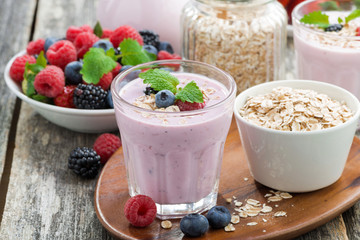 berry smoothie with oatmeal in a glass on wooden table