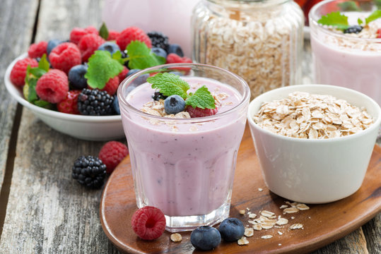 berry smoothie with oatmeal in a glass on wooden table