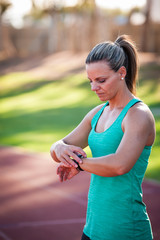 image of a female athlete adjusting her heart rate monitor