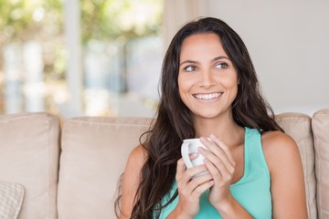 Pretty brunette holding her mug