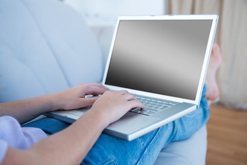 Woman using her laptop on couch