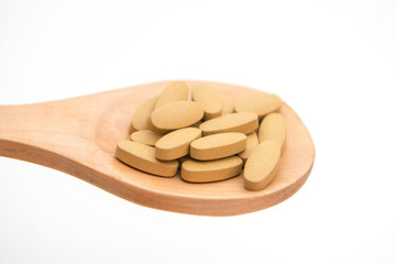 drug tablet on wood ladle for sick people